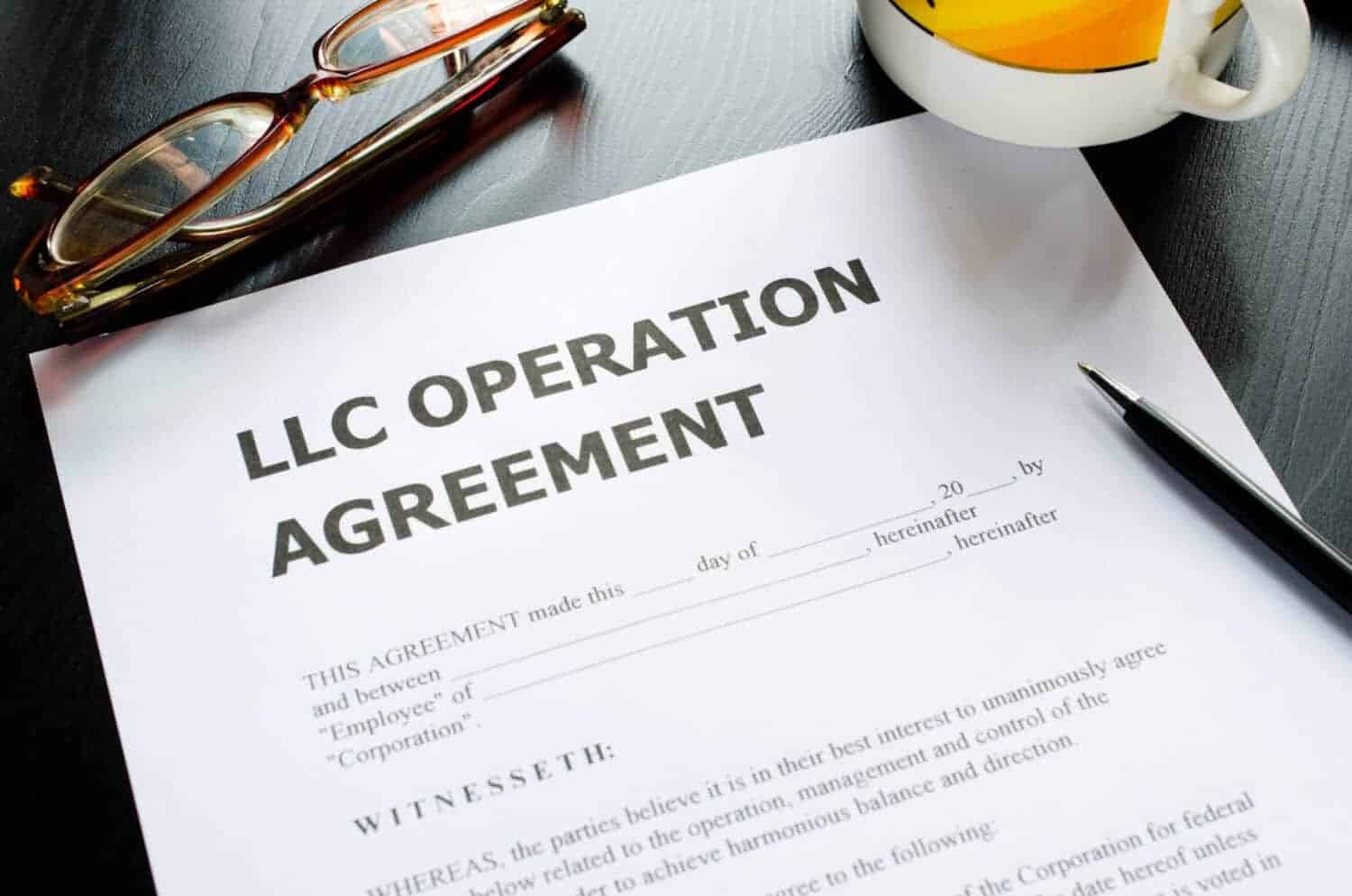 A limited liability company operation agreement with pen on a table